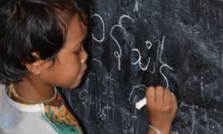 Girl Writing her name in Marma