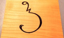 Cherry coaster carved with Sora Sompeng letter P. Carving and photo by Tim Brookes. Sora Sompeng coaster