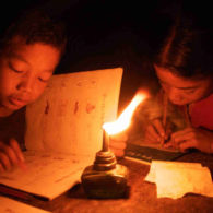 Mru children studying at night; Pora Para, Bandarban. 2005. Working on Mru by candlelight