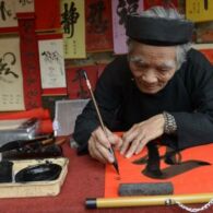A calligrapher writes down best wishes for the lunar new year or Tet in Vietnamese, for customers outside the Temple of Literature in downtown Hanoi on February 8, 2013. Photo credit: Yahoo News A calligrapher writes down best wishes for the lunar new year or Tet in Vietnamese, for customers outside the Temple of Literature in downtown Hanoi