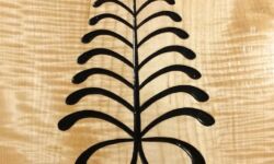 Aya, the fern. As the fern is hardy, flourishing everywhere, so the Aya symbol stands for resilience and resourcefulness. Carving and photo by Tim Brookes. Aya carving